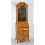 AN EARLY GEORGIAN STYLE WALNUT BUREAU CABINET, 20th century, the arched top with cavetto cornice,