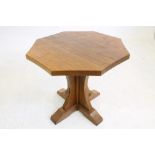 AN ADZED OAK OCCASIONAL TABLE by Robert Thompson, the octagonal top with mildly concave sides, on
