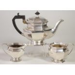 A SILVER THREE PIECE TEA SERVICE, maker's mark FC, Sheffield 1947, of octagonal baluster form on a