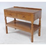 AN ADZED OAK SIDE TABLE by Robert Thompson, the moulded edged top with ledge back, two frieze