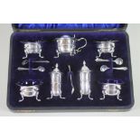 AN EDWARDIAN SILVER SEVEN PIECE CRUET, maker Wm. Davenport, Birmingham 1909 (one salt 1907 and