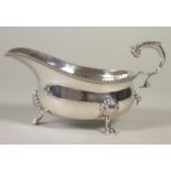 A SILVER SAUCEBOAT, maker Wm. Greenwood, London 1939, the plain oval bowl with applied gadrooned