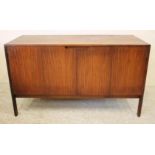 A SCANDINAVIAN DESIGN TEAK CABINET, 1960's/70's, of low oblong form, the fascia with a pair of