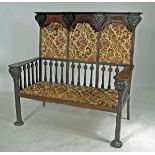 AN ART NOUVEAU MAHOGANY THREE SEATER HIGH BACK SETTLE in the manner of Shapland & Petter, the