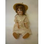 A Simon & Halbig bisque head girl doll with brown glass sleeping eyes, open mouth and teeth, brown