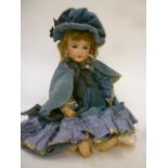An Armand Marseille bisque head doll with blue glass sleeping eyes, open mouth and teeth, fair