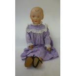 A Gebruder Heubach bisque head doll with painted face, intaglio eyes, moulded hair, jointed