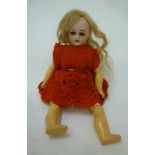 A Simon & Halbig bisque head doll with brown glass sleeping eyes, open mouth and teeth, blonde