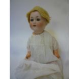 An Otto Gans bisque head character doll with blue glass sleeping eyes, open mouth and teeth,