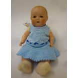 An Armand Marseille bisque head baby doll with brown glass sleeping eyes, open mouth and teeth,