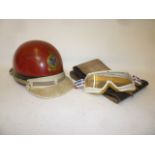A Motorcyle helmet with label and transfer for the Isle of Man T.T. Races 1961, a pair of goggles