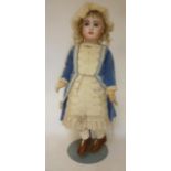 A Tete Jumeau Bebe with fixed blue glass eyes, closed mouth, pierced ears, blonde mohair wig,