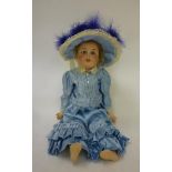 A Limoges bisque head doll with blue glass sleeping eyes, open mouth and teeth, pierced ears, fair