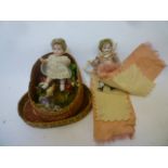 An all bisque dolls house doll with blue glass eyes, brown mohair wig, swivel joints, dressed as pin