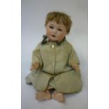 An Armand Marseille bisque head character doll with blue glass sleeping eyes, open mouth and