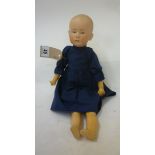 A Gebruder Heubach bisque head "Solemn Boy" doll with painted mouth, intaglio eyes, moulded hair,