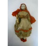 A papier mache shoulder head doll, c.1840, with inset brown glass eyes, blonde mohair wig, stuffed