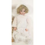 A Kammer & Reinhardt bisque head doll with brown glass flirty eyes, open mouth and teeth, pierced