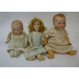 Three Armand Marseille bisque head dolls, a Flora Dora with brown glass sleeping eyes, open mouth