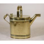 A VICTORIAN BRASS WATERING CAN of oval form with ribbed banding, split hinged lid and loop