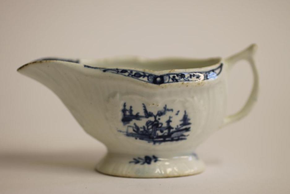 A FIRST PERIOD WORCESTER PORCELAIN SMALL SAUCEBOAT, c.1770, painted in underglaze blue with the "