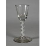 A GEORGIAN WINE GLASS, the round funnel bowl on a plain stem containing two pairs of spiral tapes