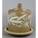 A VICTORIAN BROWN SMEARGLAZED STONEWARE CHEESE STAND AND DOME, of cylindrical form, moulded and