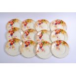 A SET OF TWELVE ROYAL WORCESTER CHINA DESSERT PLATES, 1933, of shaped circular form painted in