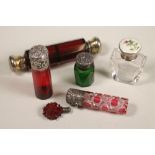 A COLLECTION OF SIX COLOURED GLASS SCENT BOTTLES, comprising a double ended ruby smelling salts