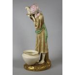 A ROYAL WORCESTER CHINA FIGURE, 1884, modelled by James Hadley as a female Eastern water carrier, in