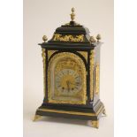 AN EBONIZED AND GILT METAL MOUNTED TABLE CLOCK of Georgian design, late 19th century, the twin