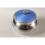 AN ART DECO GLASS AND SILVER DRESSING TABLE BOX of squat globular form with star cut base and