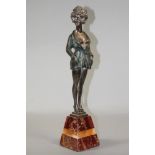 AN ART DECO COLD PAINTED SILVERED METAL FIGURE, in the style of Bruno Zach, the young lady wearing