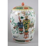 A CHINESE PORCELAIN JAR AND COVER of rounded cylindrical form, painted in polychrome enamels with