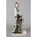 AN ART DECO KATZHUTTE EARTHENWARE FIGURE modelled as a stylish young lady wearing a hat and blue