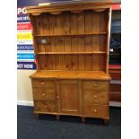 A 19th c pine dresser with central cupboard flanked by two banks of three drawers