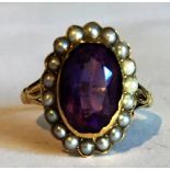 Amethyst and seed pearl ring set in yellow metal.