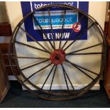 Two vintage metal cart wheels