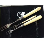 Three silver and ivory forks.