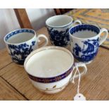 Three blue and white cups and one blue and gilt.