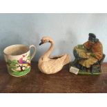 A 19th c French pottery figure of a lacemaker, another figure of a swan and a naively painted