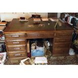 Large oak pedestal partners desk with green leather inset.