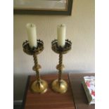 Pair of large brass candlesticks of ecclesiastical shape.