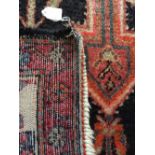 Oriental handknotted wool rug. 225cms lx 142w