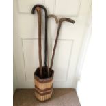 Bamboo stick stand and four walking sticks.