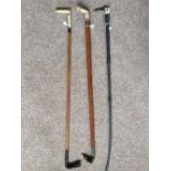 Three riding crops with bone handles, one with a whistle.