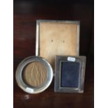 Three silver photograph frames.