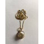 Eighteen carat gold chain and dice pendant 6.8gms.