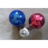 Two coloured witch balls.