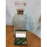 Boxed silver golf tee and ball marker together with cufflinks and silver necked decanter.